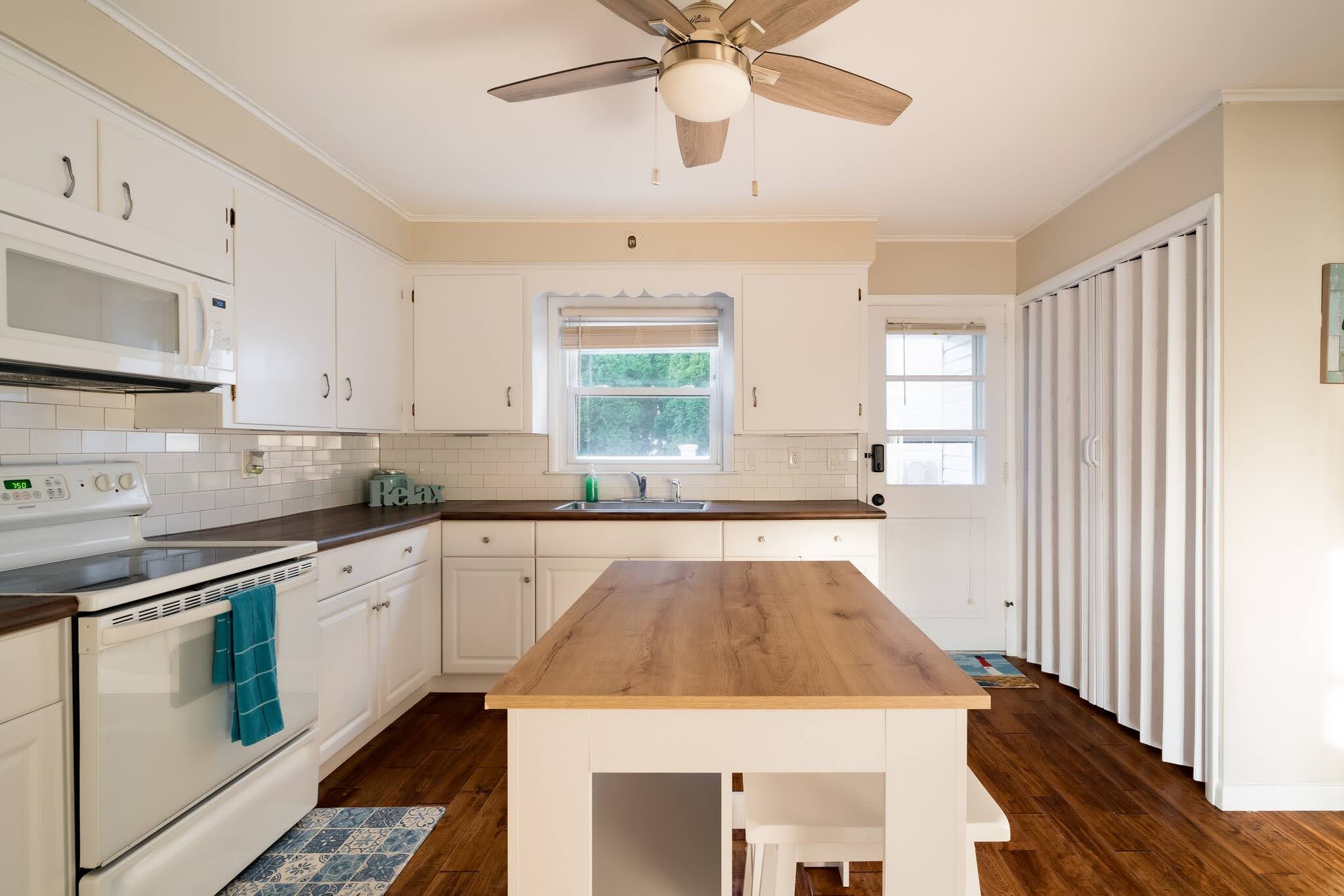 Full kitchen with island and modern appliances